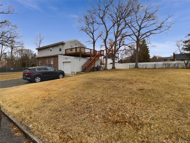 view of yard featuring stairs, fence, and a wooden deck