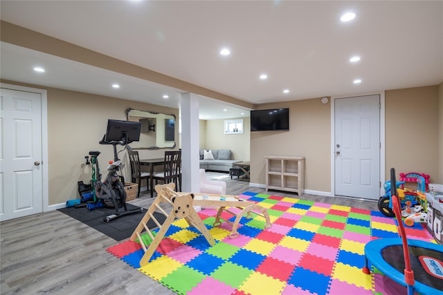 playroom with baseboards, wood finished floors, and recessed lighting