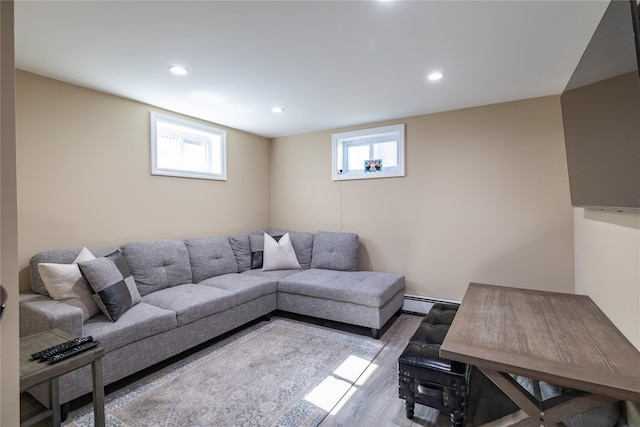 living room featuring recessed lighting, light wood-style flooring, and a baseboard radiator