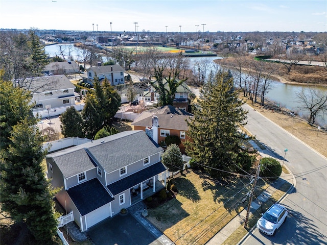 birds eye view of property with a water view and a residential view