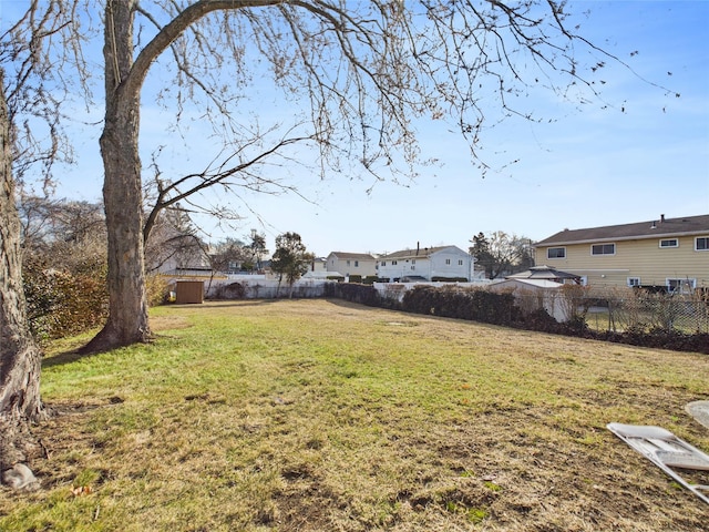 view of yard with fence and a residential view