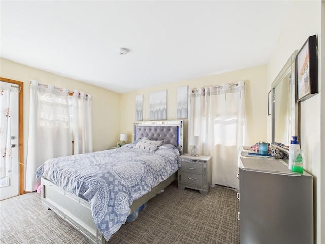 bedroom featuring dark colored carpet