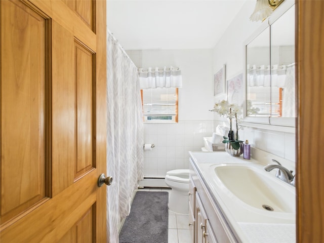 full bathroom featuring tile patterned flooring, toilet, a baseboard heating unit, vanity, and tile walls