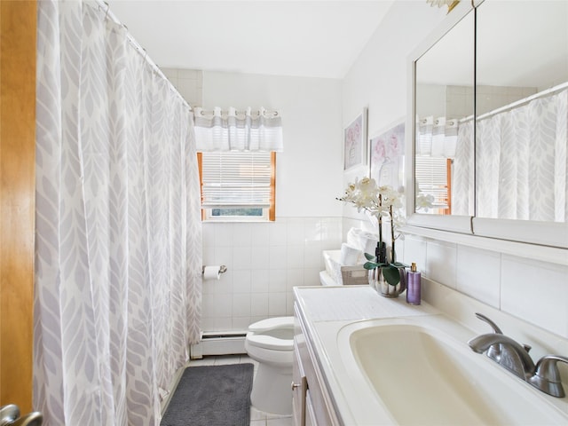 full bath featuring toilet, vanity, tile walls, baseboard heating, and tile patterned floors