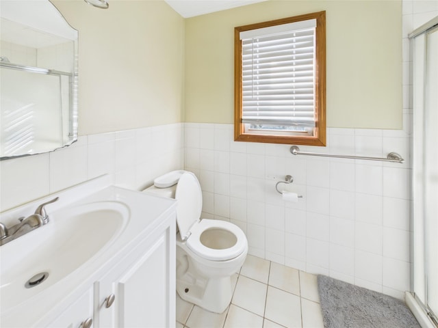 full bath featuring toilet, vanity, tile walls, tile patterned floors, and a stall shower