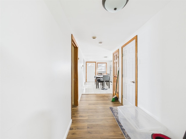 hallway with wood finished floors and baseboards