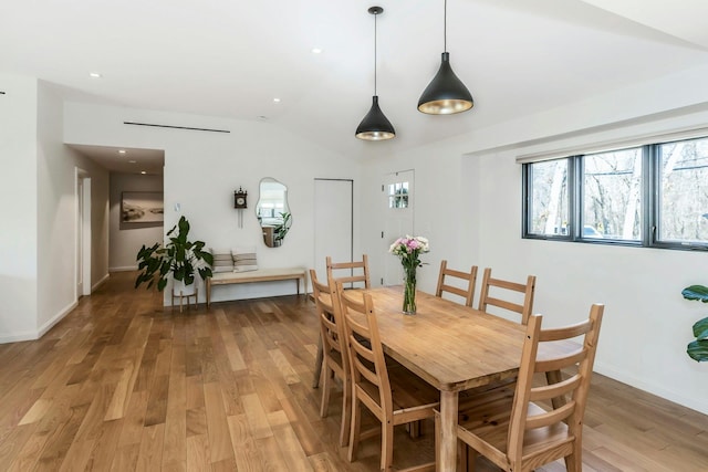 dining area with recessed lighting, baseboards, vaulted ceiling, and light wood finished floors