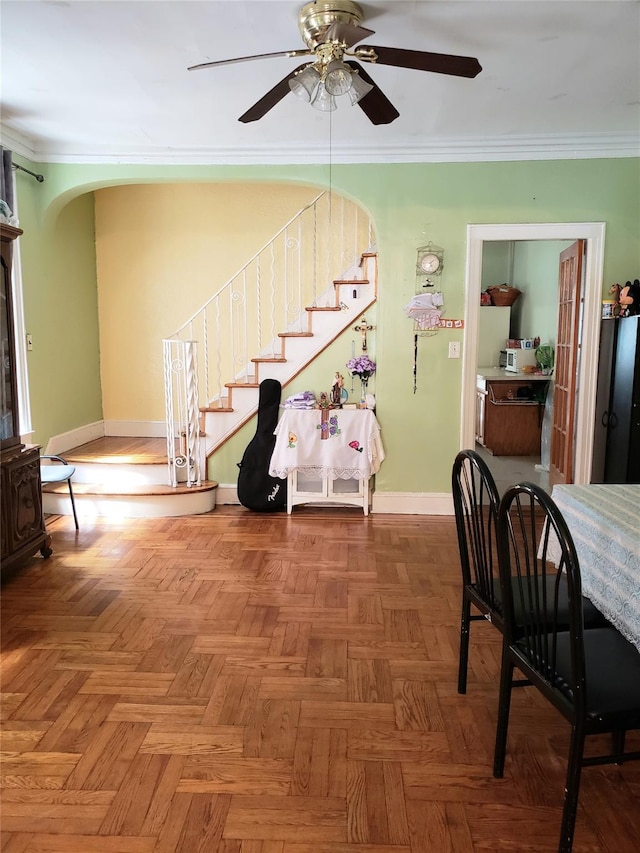 interior space with arched walkways, crown molding, baseboards, and stairs