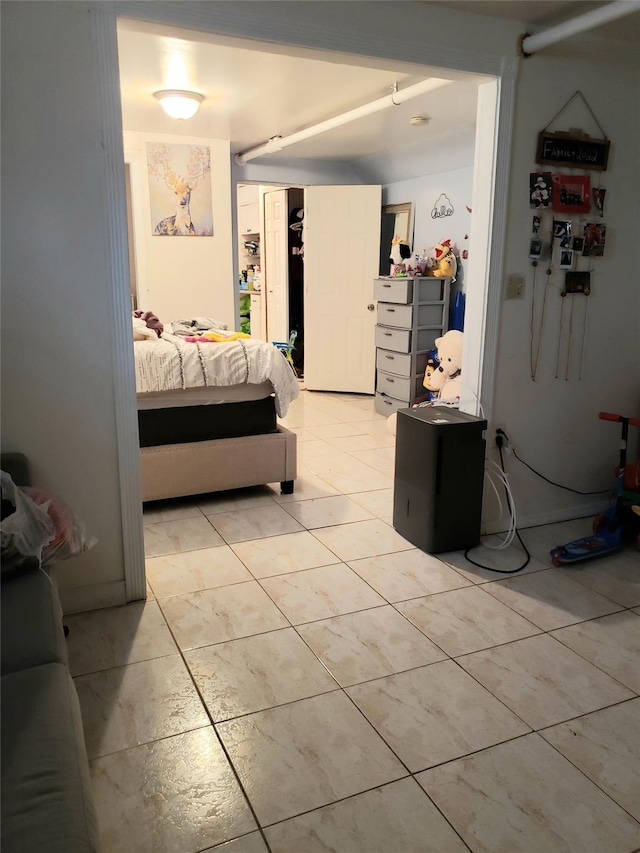 bedroom featuring a closet and light tile patterned flooring