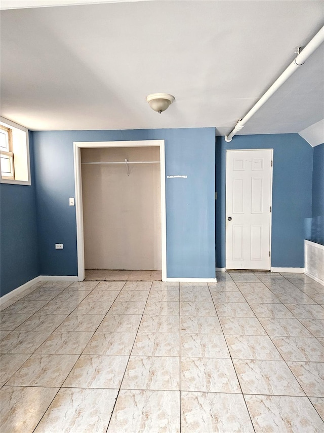 30-32 84th St, East Elmhurst, NY 11370 - unfurnished bedroom featuring a closet and baseboards