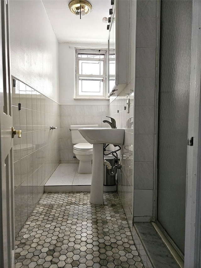 30-32 84th St, East Elmhurst, NY 11370 - bathroom featuring toilet, tile walls, and a sink