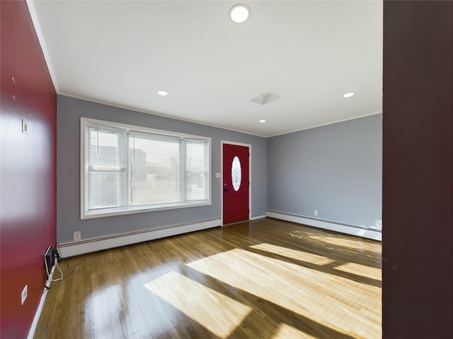 entrance foyer featuring ornamental molding, recessed lighting, baseboard heating, and wood finished floors