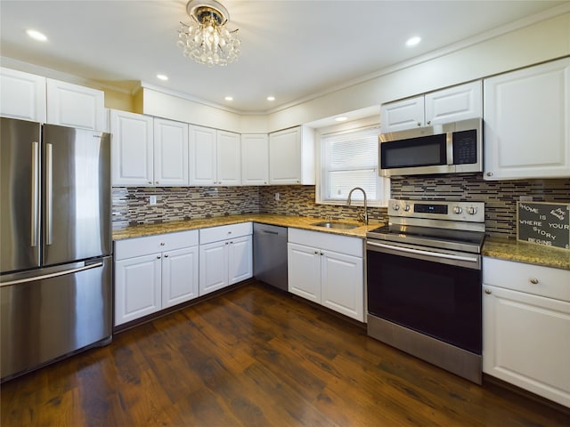 kitchen with white cabinets, appliances with stainless steel finishes, dark wood-type flooring, and a sink