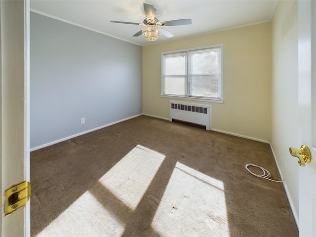 carpeted spare room featuring radiator heating unit, ornamental molding, ceiling fan, and baseboards