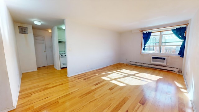 164-20 Highland Ave Unit 8W, Jamaica, NY 11432 - empty room featuring a baseboard heating unit, light wood-style flooring, and a wall mounted AC