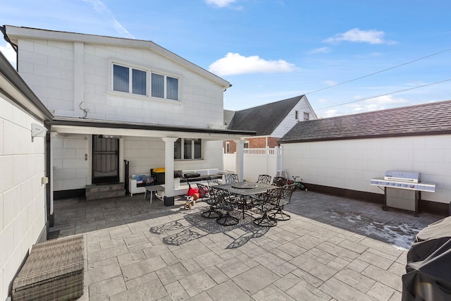 view of patio / terrace with a grill and fence