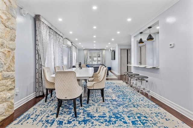 dining room featuring ornamental molding, recessed lighting, a wall unit AC, and dark wood finished floors