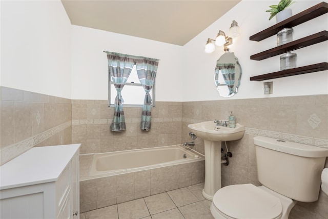 bathroom featuring tile patterned flooring, a garden tub, tile walls, and toilet