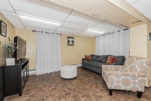 living room with a baseboard radiator, baseboard heating, and a drop ceiling