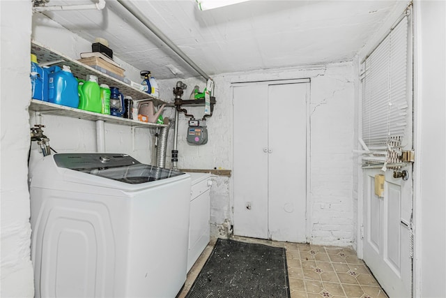 clothes washing area featuring laundry area and separate washer and dryer