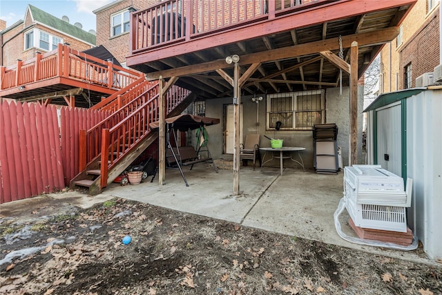 view of patio featuring a shed, stairway, and a wooden deck