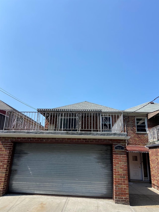 view of front of property with a garage and brick siding