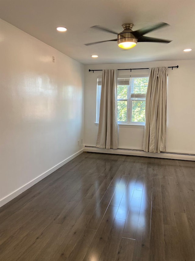 empty room with a baseboard radiator, recessed lighting, a ceiling fan, baseboards, and dark wood finished floors