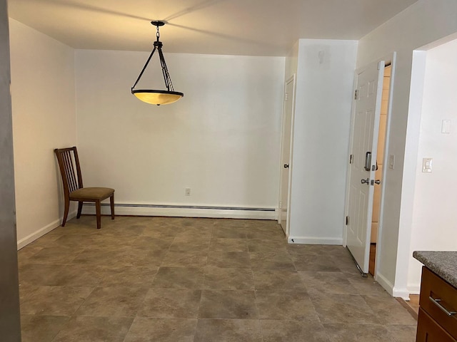 unfurnished dining area featuring baseboards and baseboard heating