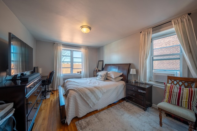 bedroom with light wood-style floors and baseboards