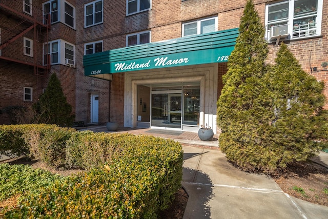 view of exterior entry with brick siding