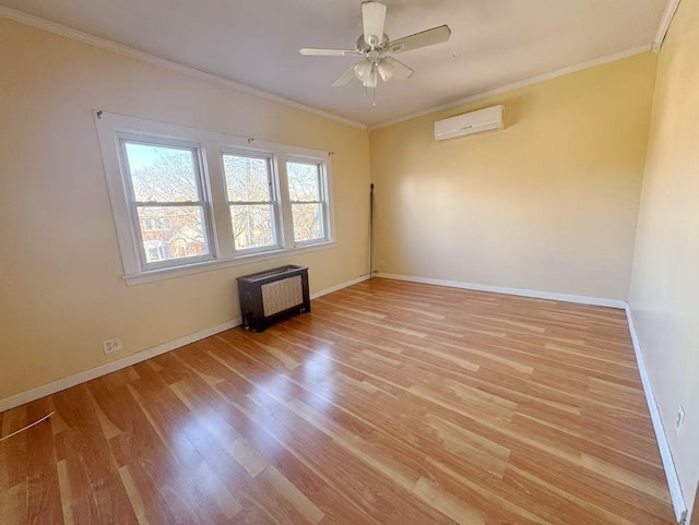 empty room with baseboards, ornamental molding, a wall mounted air conditioner, and light wood-style floors