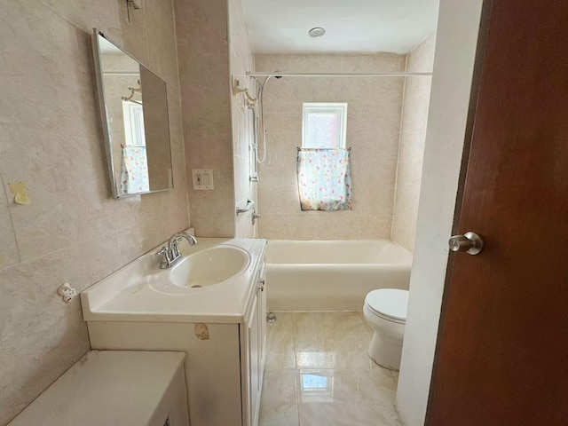 full bathroom with toilet, shower / tub combination, tile walls, and vanity