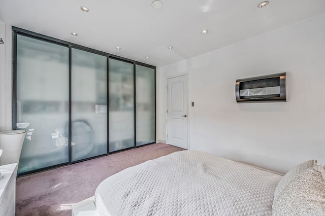 bedroom with recessed lighting, carpet, and a closet