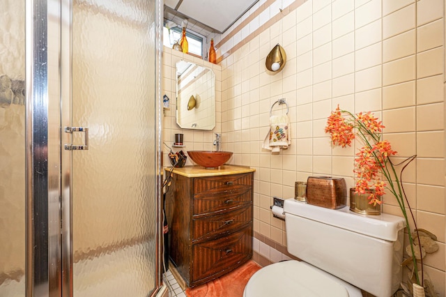 bathroom featuring vanity, tile walls, toilet, and a stall shower