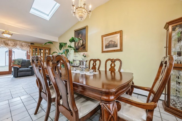 dining room with lofted ceiling with skylight, light tile patterned floors, and an inviting chandelier