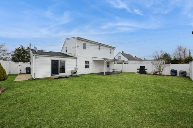 back of property featuring a fenced backyard, a gate, a patio, and a yard