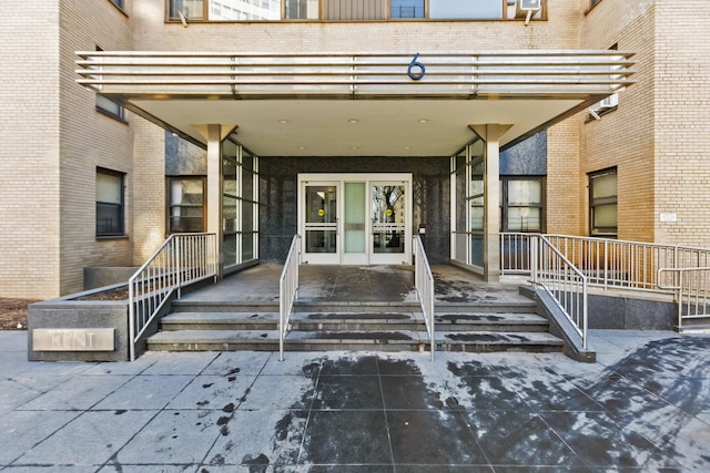 doorway to property featuring brick siding