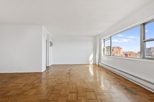 unfurnished room featuring a baseboard heating unit