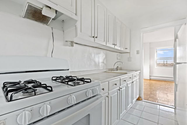 kitchen featuring light countertops, white appliances, a sink, and white cabinets