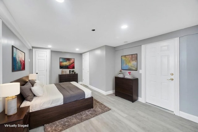 bedroom with light wood finished floors, baseboards, and recessed lighting