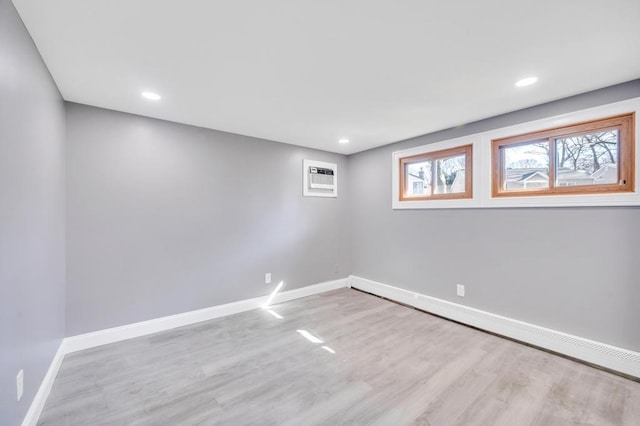 spare room with recessed lighting, wood finished floors, and baseboards