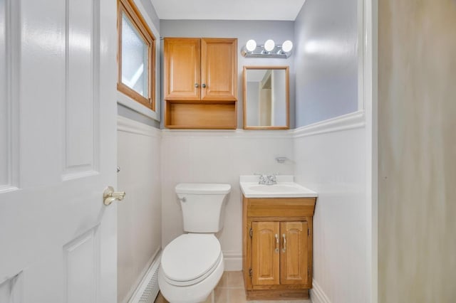 bathroom with toilet, baseboards, and vanity