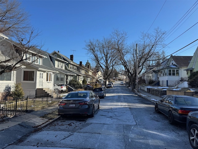 view of street featuring a residential view, curbs, and sidewalks