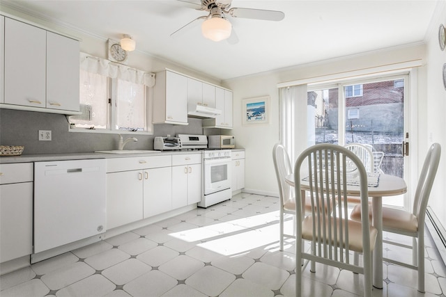 kitchen featuring under cabinet range hood, white appliances, a sink, ornamental molding, and light floors