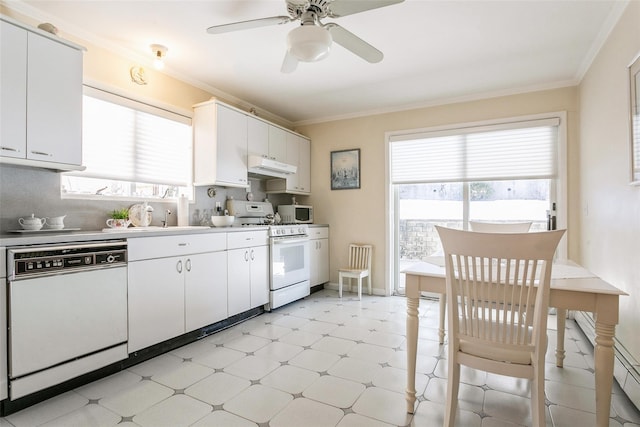 kitchen featuring white appliances, under cabinet range hood, ornamental molding, and light floors