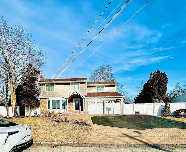 view of front of house with fence, a chimney, and a front lawn