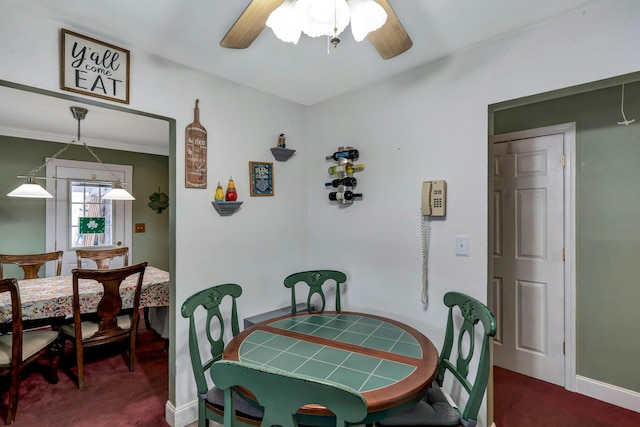 dining room featuring ceiling fan, baseboards, and carpet flooring