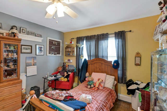 bedroom with baseboards, ceiling fan, baseboard heating, and wood finished floors