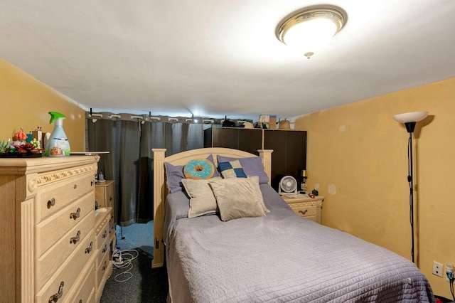 bedroom featuring dark colored carpet