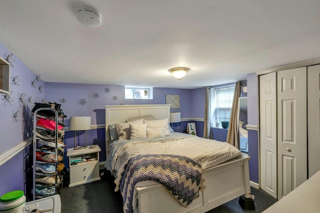 bedroom with dark colored carpet and a closet